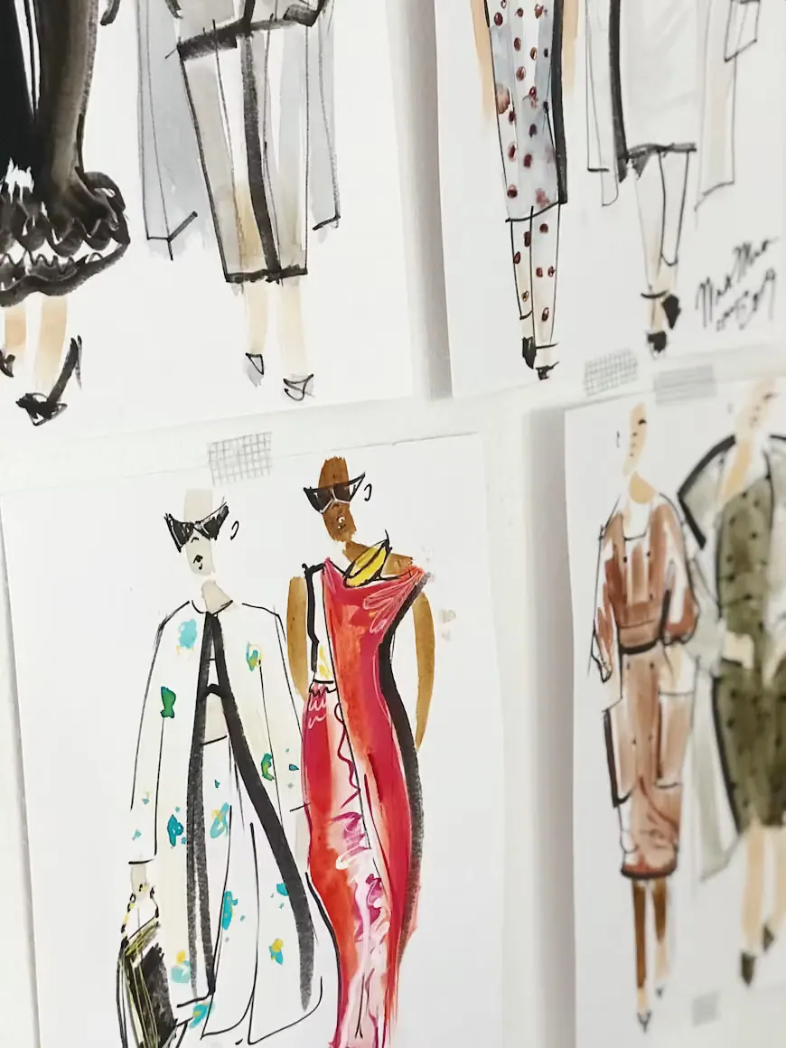 Pages of clothing sketches with pencils and markers